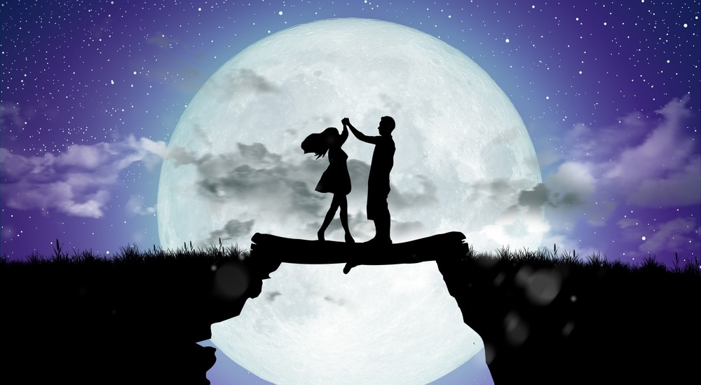 Silhouette of fantasy couple dancing under the moon representing dangerous forbidden love in fantasy